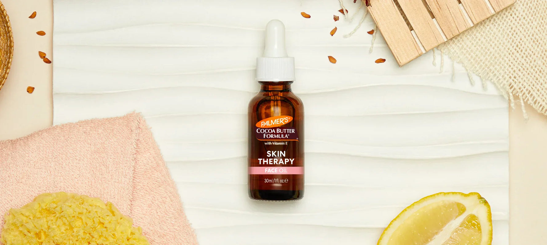 Palmer's Skin Therapy Face Oil on wooden background with ingredients around it