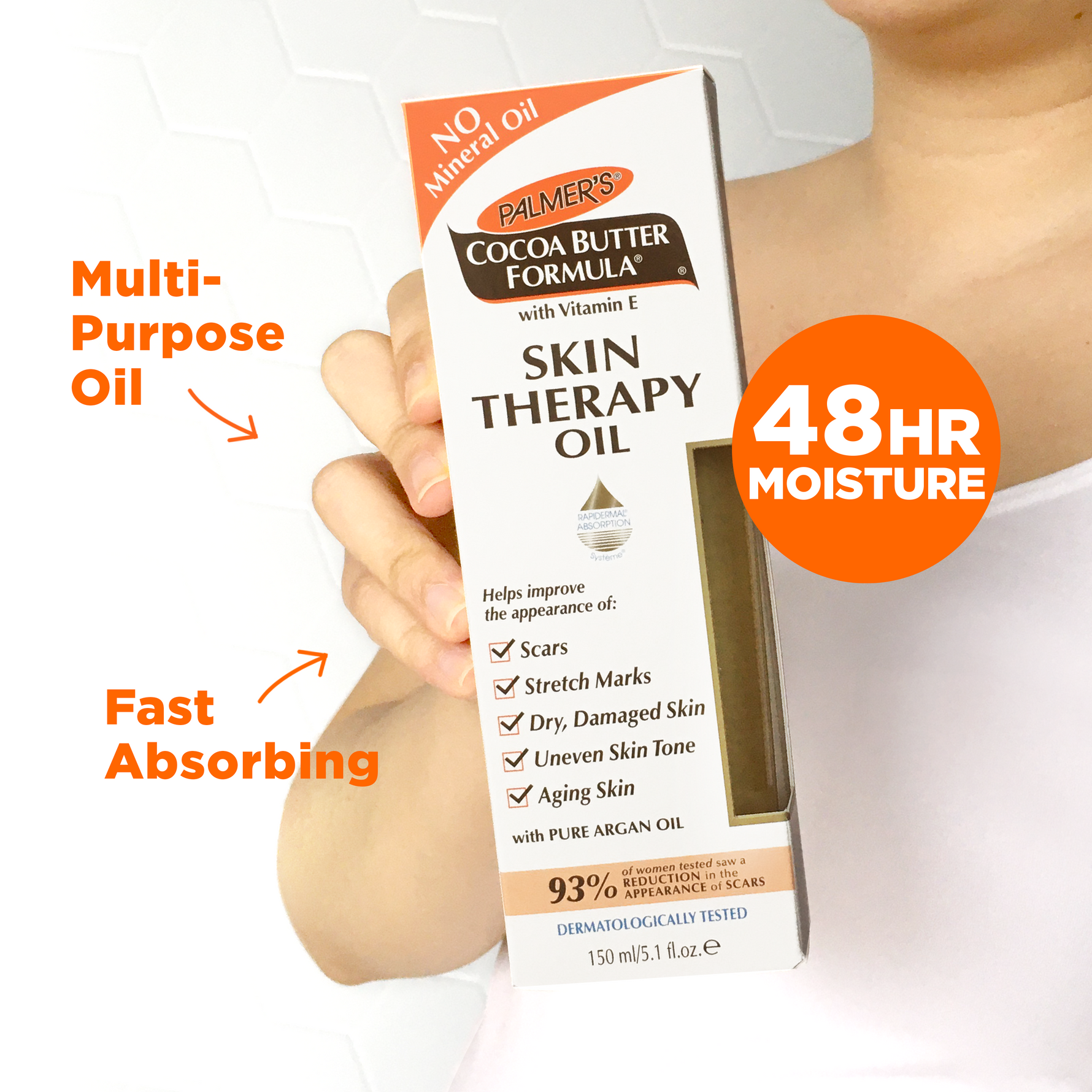 Hand holding Palmer's Cocoa Butter Skin Therapy Oil with Vitamin E box.